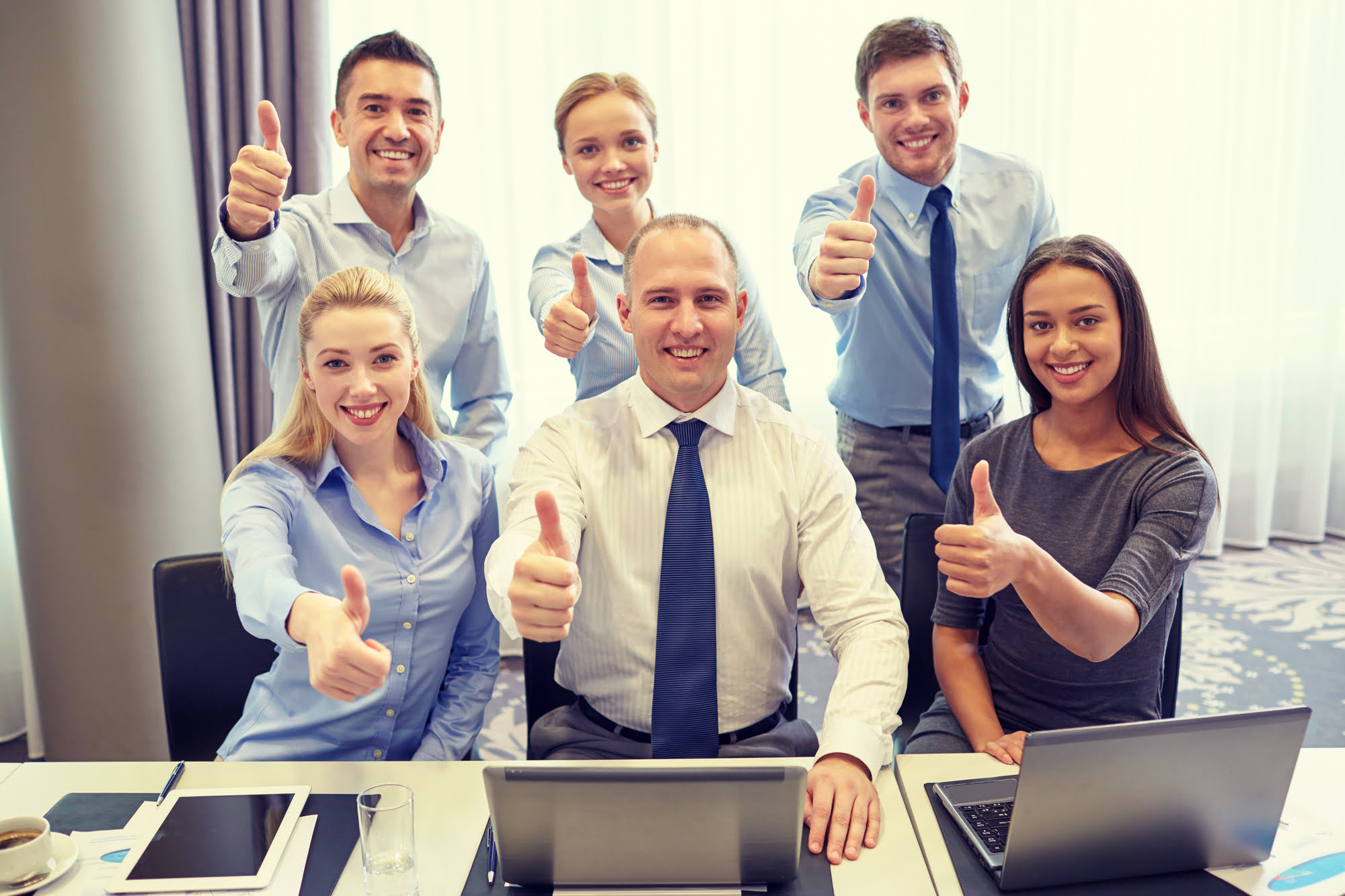 business people showing thumbs up in office unstructured data technology