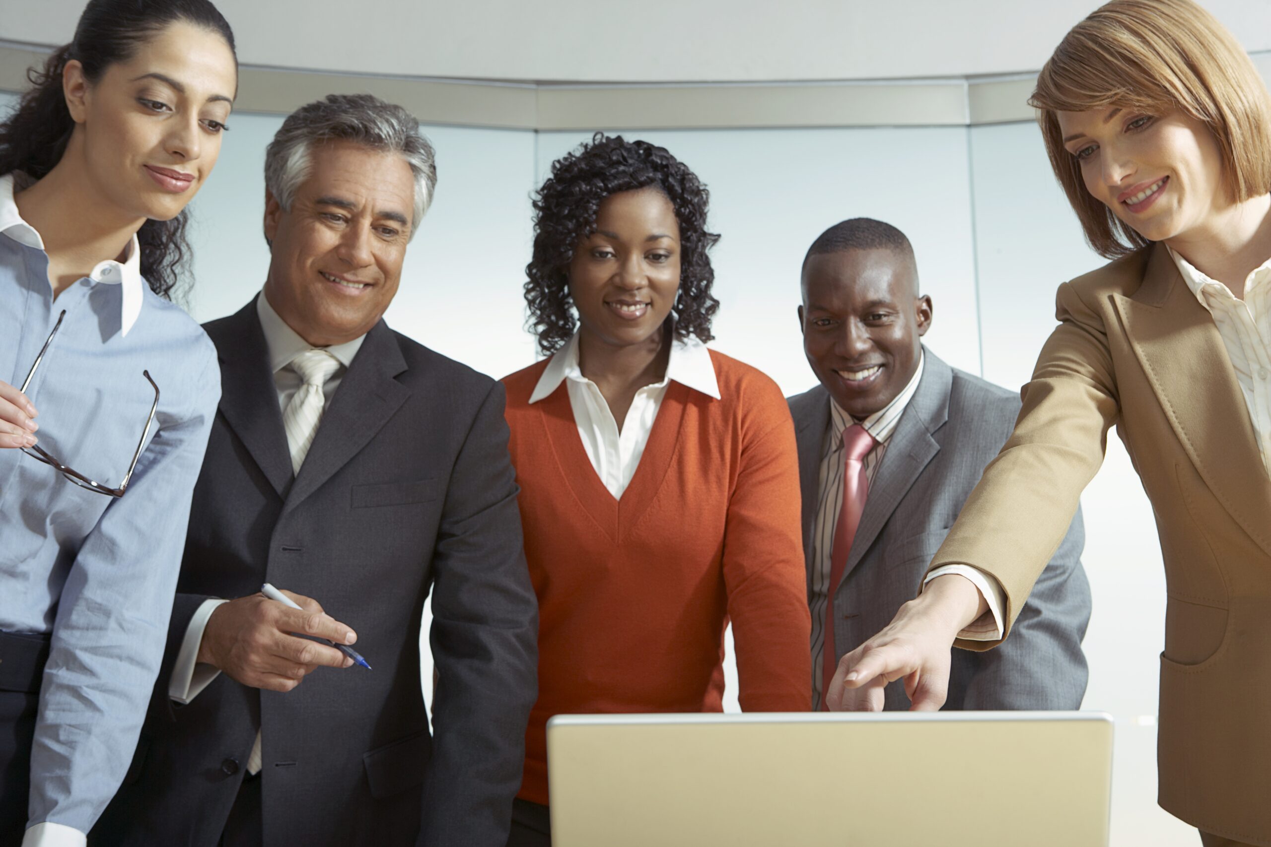 Businesspeople looking at a laptop Businesspeople looking at a laptop